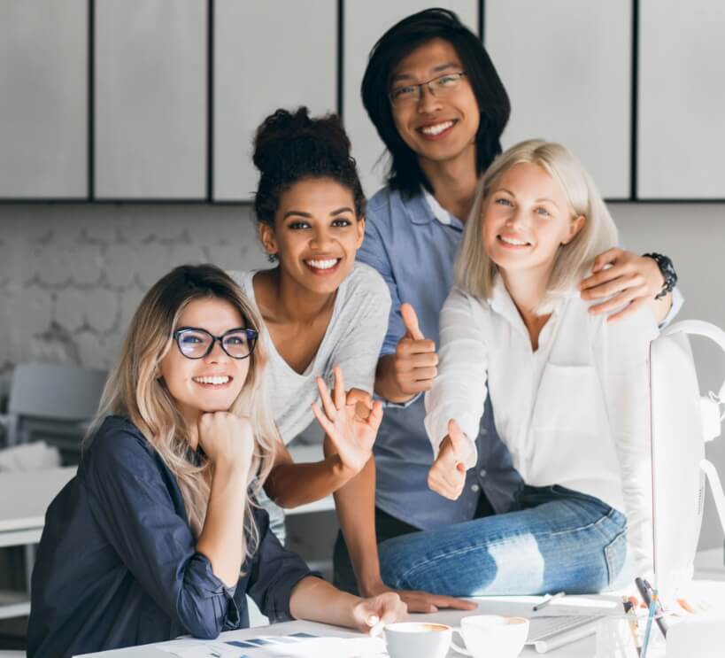 blissful-asian-programmer-embracing-female-blonde-colleague-photo-smiling-indoor-portrait-glad-african-office-worker-posing-beside-european-friend-her-workplace-819x74