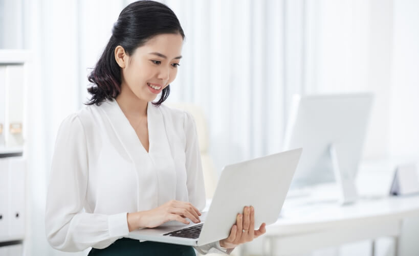 charming-ethnic-businesswoman-using-laptop