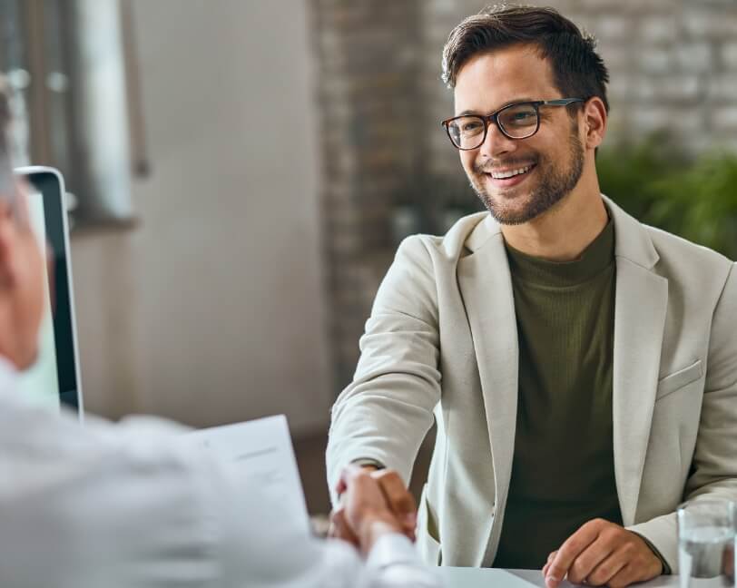 happy-male-candidate-handshaking-with-manager-after-successful-job-interview-office