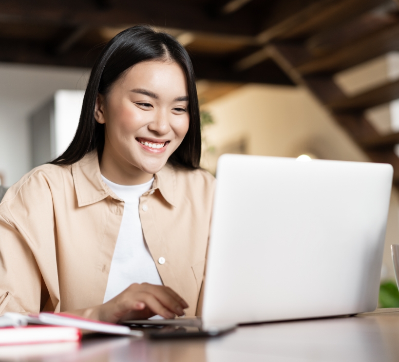 smiling-asian-girl-waching-webinar-having-work-video-call-from-home-working-freelance-remotely-looki