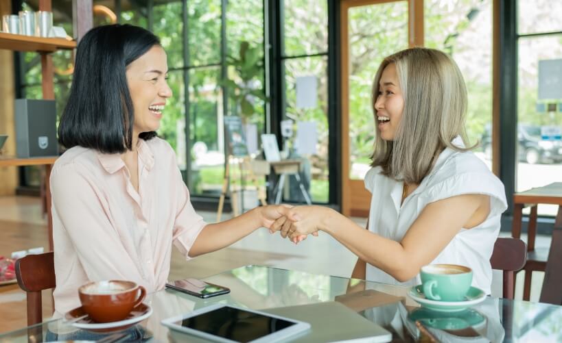 two-businesswomen-shaking-hands-local-coffee-shop-two-women-discussing-business-projects-cafe-while-having-coffee-startup-ideas-brain-storm-concept-us